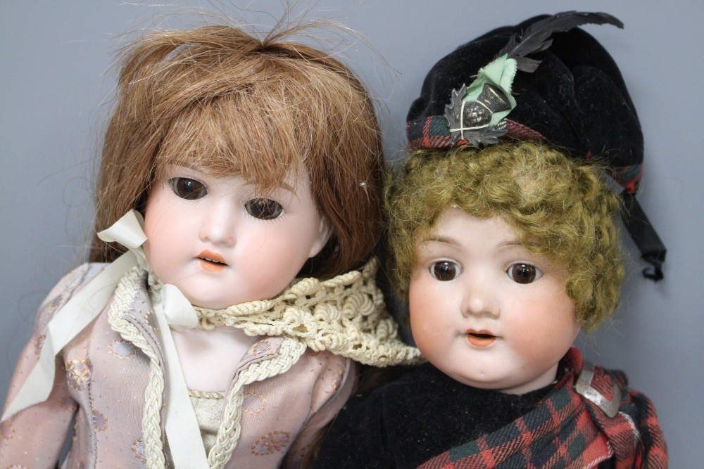 Two Armand Marseilles bisque head dolls, Floradora AOM, overall length 49cm and a child doll in Scots dress 390A2M, 44cm